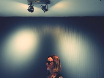 Portrait of woman with light painting on wall