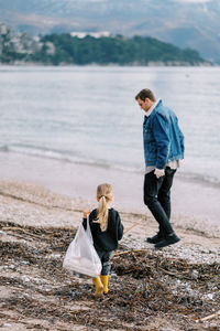 Rear view of boy walking on beach