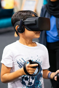 Boy wearing virtual reality simulator