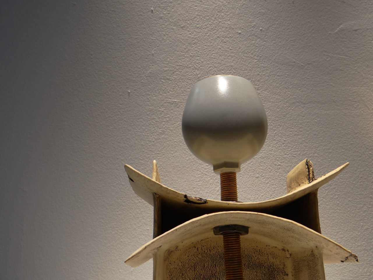 CLOSE-UP OF ELECTRIC LAMP AGAINST WALL