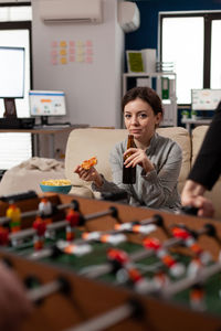 Portrait of woman eating pizza