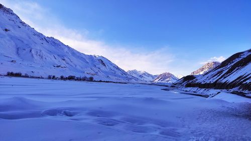 Scenic view of snowcapped mountains against sky