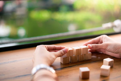 Cropped image of people holding table