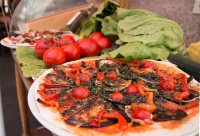 Rustic pizza with fresh vegetables on table for two