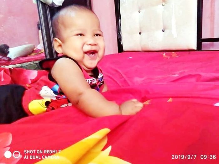 baby, child, childhood, one person, happiness, smiling, emotion, cute, innocence, portrait, toddler, babyhood, baby clothing, cheerful, clothing, looking at camera, indoors, lifestyles, person, sitting, fun, full length, positive emotion, laughing, toy, pink, day, joy, enjoyment