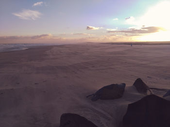 Scenic view of beach against sky during sunset