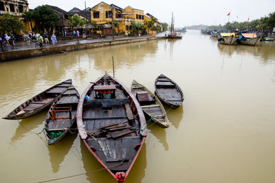 Boats moored in lake against sky