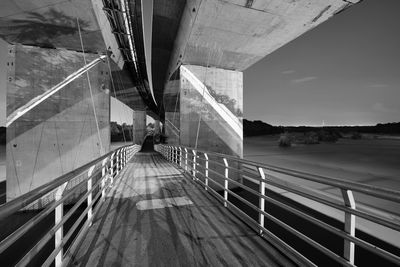 Man on bridge against sky