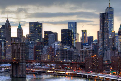 View of skyscrapers in city against cloudy sky