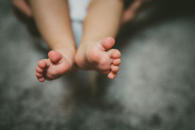 Low section of baby feet