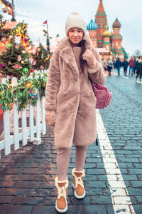 Low section of woman standing on footpath
