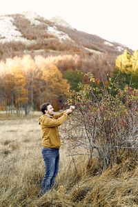 Full length of man photographing while standing on mountain