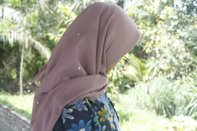 Rear view of woman wearing hat against trees