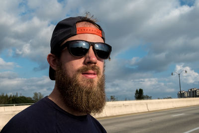 Portrait of man wearing sunglasses against sky