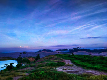 Scenic view of landscape against sky at dusk