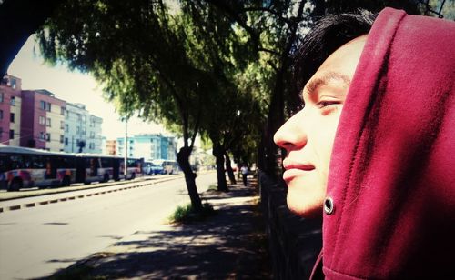 Portrait of boy looking away on street in city