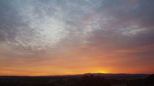 Scenic view of silhouette mountain against sky during sunset