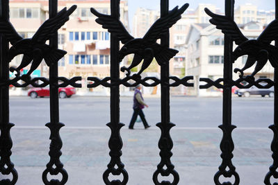 Close-up of metal fence against building