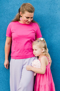 High angle view of cute baby girl with mother carrying daughter