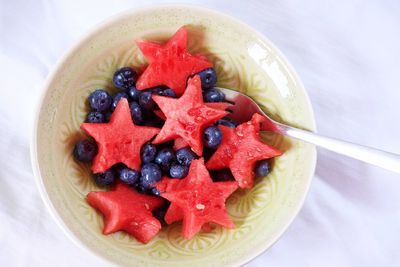 High angle view of star shape watermelons and blueberries in bowl