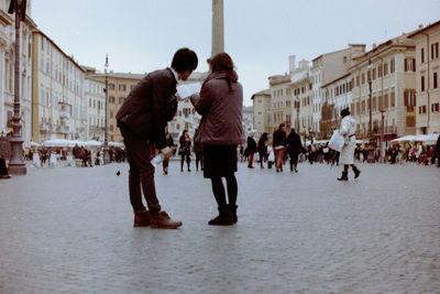 People walking on street in city during winter