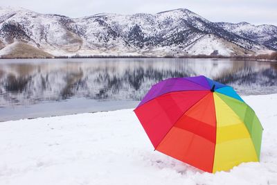 Multi colored umbrella on snow