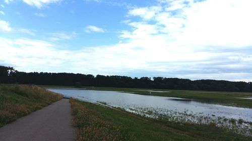 Scenic view of landscape against cloudy sky