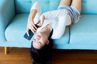 High angle view of baby lying on sofa at home