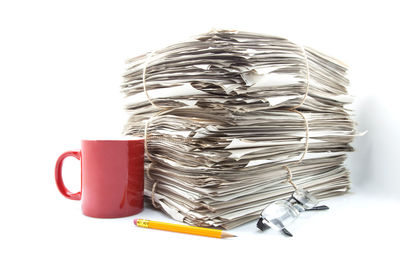 Close-up of coins on table against white background