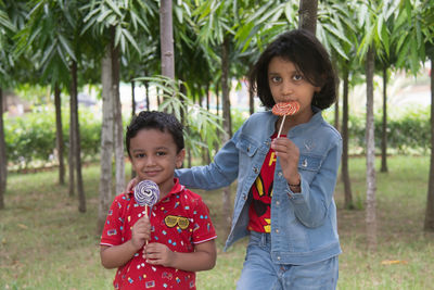 Kids with candy posing in garden