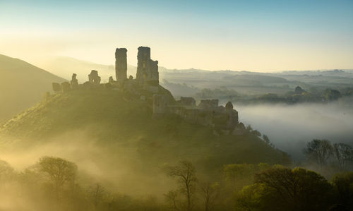 Castle on mountain against sky