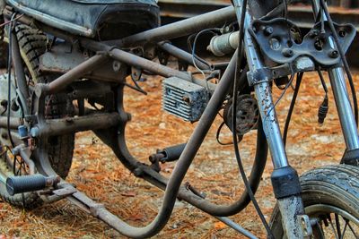 Close-up of old rusty bicycle on field