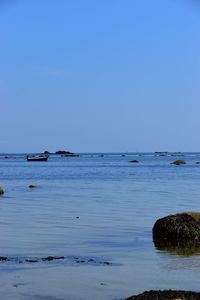 Scenic view of sea against clear blue sky