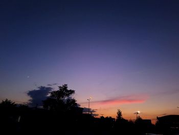 Low angle view of silhouette trees against sky at sunset