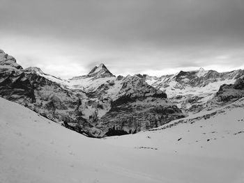 Scenic view of snow covered mountains against sky