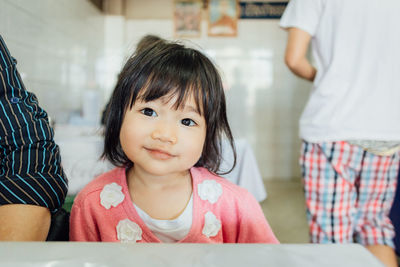 Portrait of cute girl sitting on father