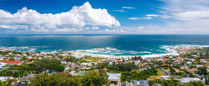 High angle view of townscape by sea against sky