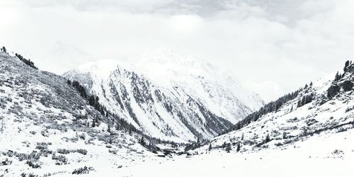 Scenic view of snow covered mountains against sky