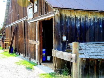 Old abandoned house on field by building