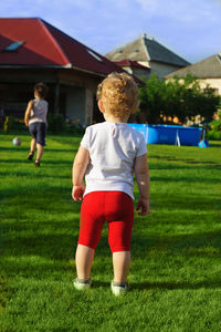 Rear view of people on field