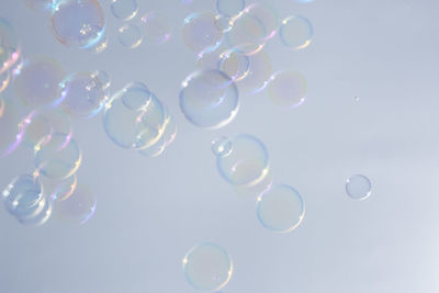 Close-up of bubbles over white background