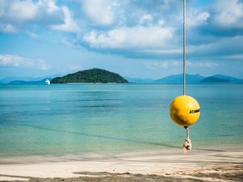 Koh kham island in peaceful turquoise sea with buoy swing. shot from koh mak island, trat, thailand.