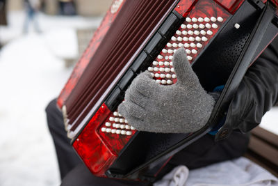 Musician playing the accordion in gloves