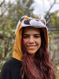 Portrait of smiling young woman wearing hood clothing