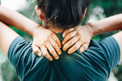 Close-up of woman with neck pain while standing outdoors