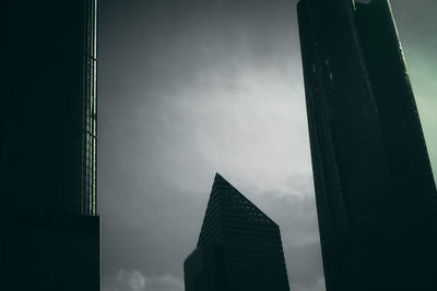 Low angle view of modern buildings against sky at dusk