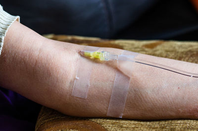 Cropped hand of woman with iv drip