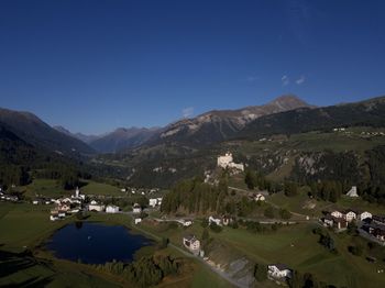 Scenic view of field and mountains against clear sky