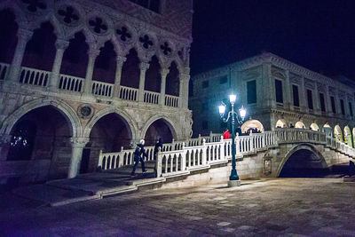 Illuminated bridge against sky at night