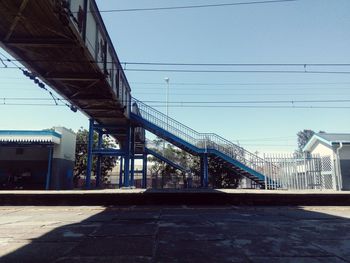 Bridge against clear blue sky in city